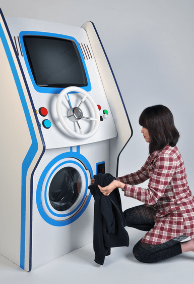 Putting Clothes in Coin Slot Game Washer Putting Clothes in Coin Slot Game Washer